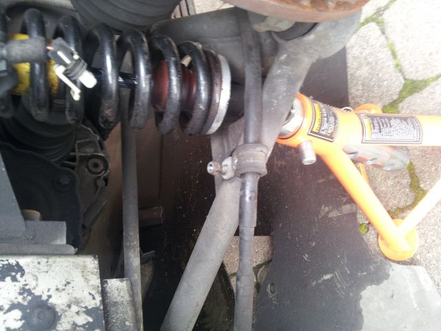 Undo the P Clip that holds the handbrake cable