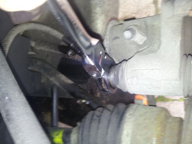 Undo the top brake caliper bolt