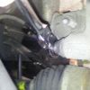 Undo the top brake caliper bolt